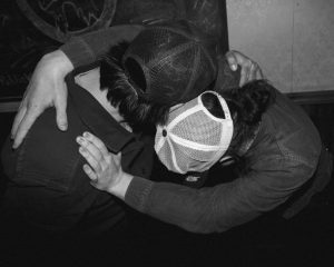 Two people hugging from a bird's eye view perspective in black and white