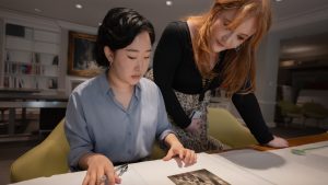 Art History MFA students Liz Chung and Jenah Creecy cateloging a Raymond Meeks acquisition in the Virginia Museum of Fine Arts Library.