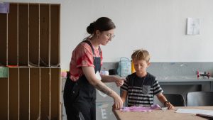 Art Education students instructing K-12 grade children during the summer Creative Arts Camp held in the DePillars Building