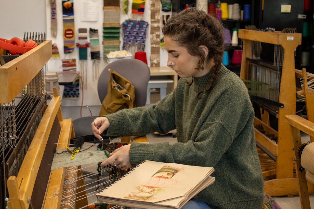 student working with fiber in the classroom