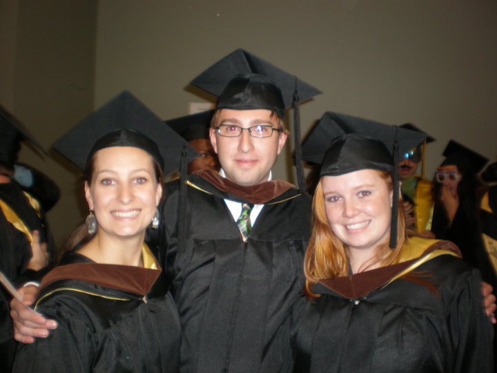 three people in graduation caps