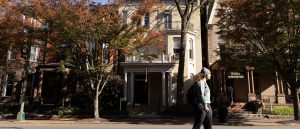 A student skateboarding past buildings on Franklin Street