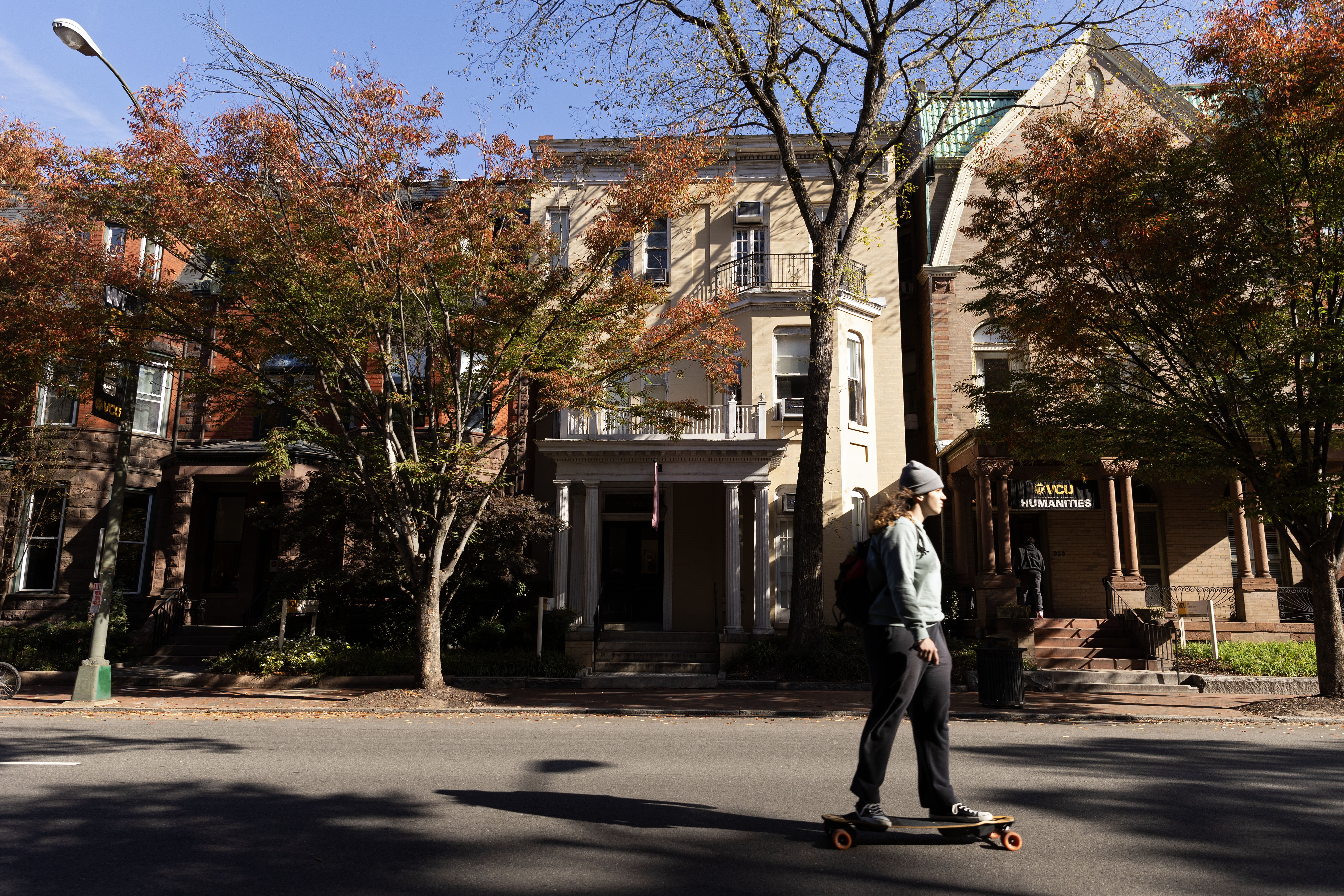 A student skateboarding past buildings on Franklin Street