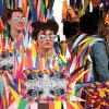 Students pose in colorful handmade paper costumes made of multicolor triangles