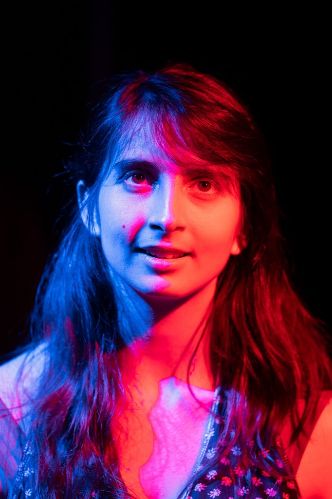 Portrait of Sirena Pearl by McNair Evans with blue and red lights on her face mimicking the colors of the thermal imaging captures