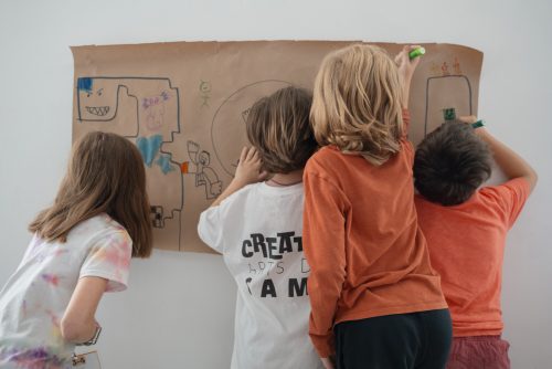 Art Education students instructing K-12 grade children during the summer Creative Arts Camp held in the DePillars Building.