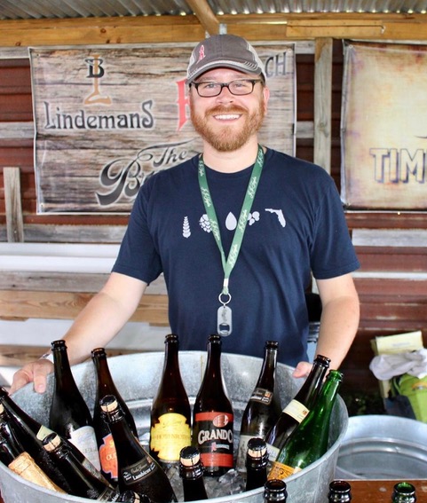 man smiling with bucket of beer