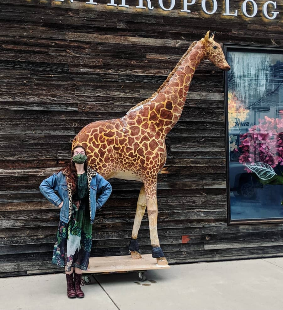 Julia standing next to a model giraffe