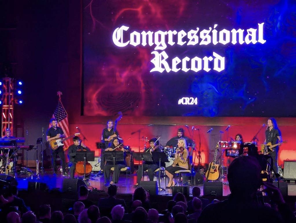 Kevin, cello, and Arianna, violin, on stage performing at the Congressional Record.