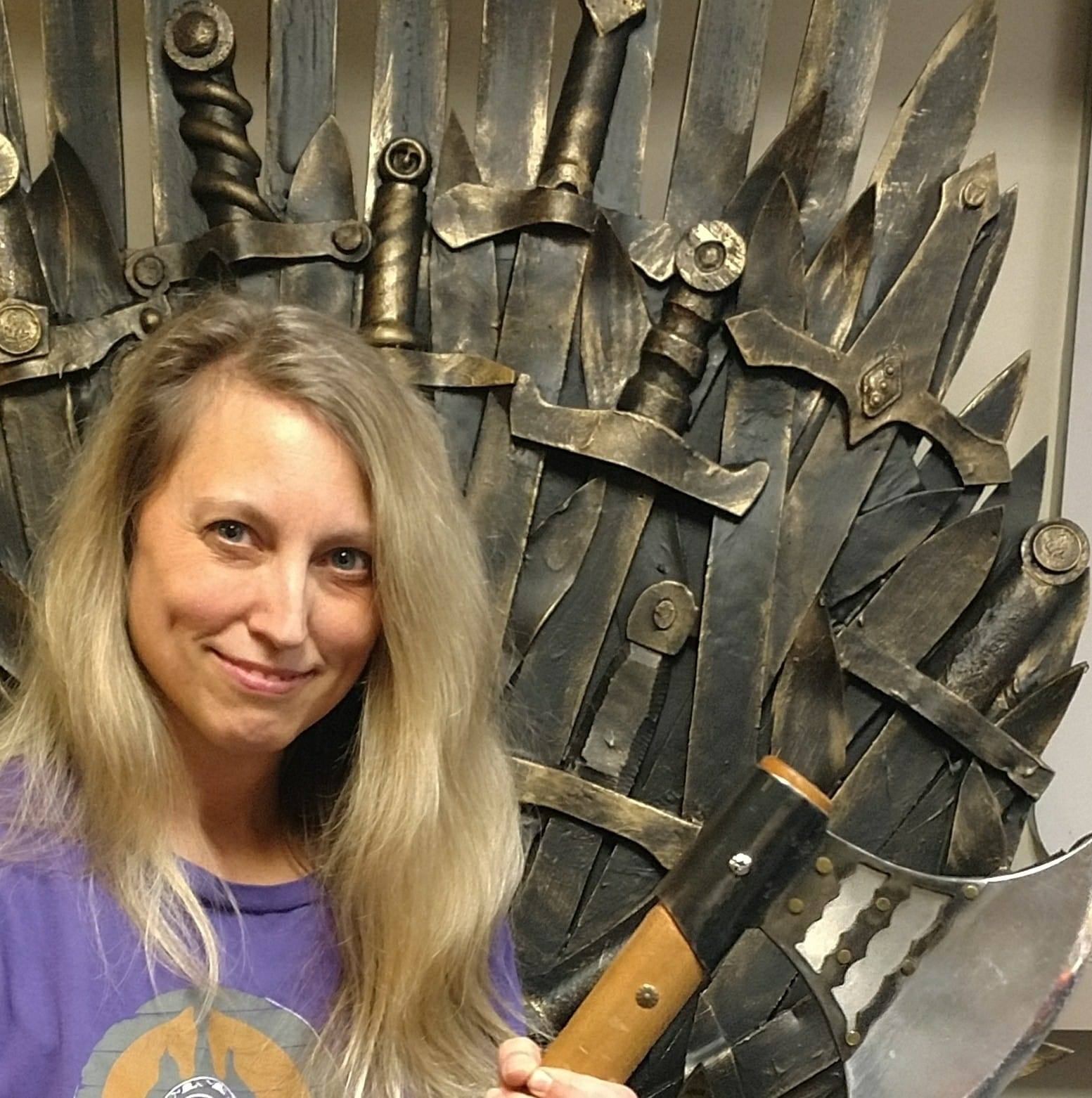 woman in front of iron swords