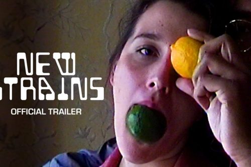 title card for the film New Strairs showing a couple's faces with a man in the background holding a lemon in front of the womans eye in the foreground while she is holding a lime in her mouth