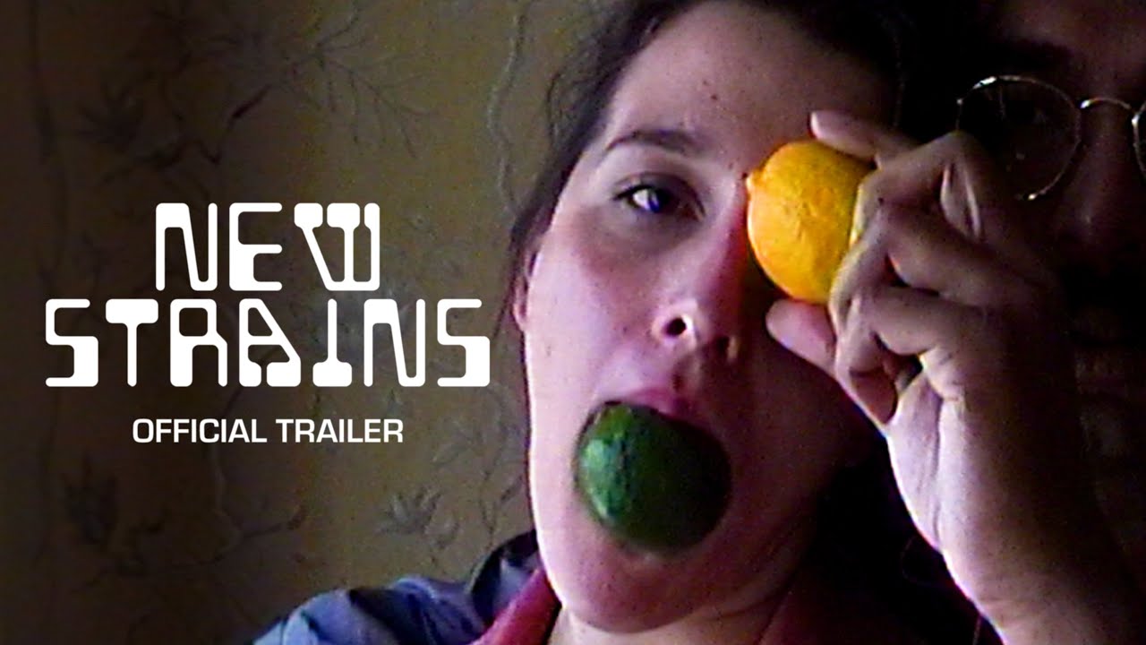 title card for the film New Strairs showing a couple's faces with a man in the background holding a lemon in front of the womans eye in the foreground while she is holding a lime in her mouth