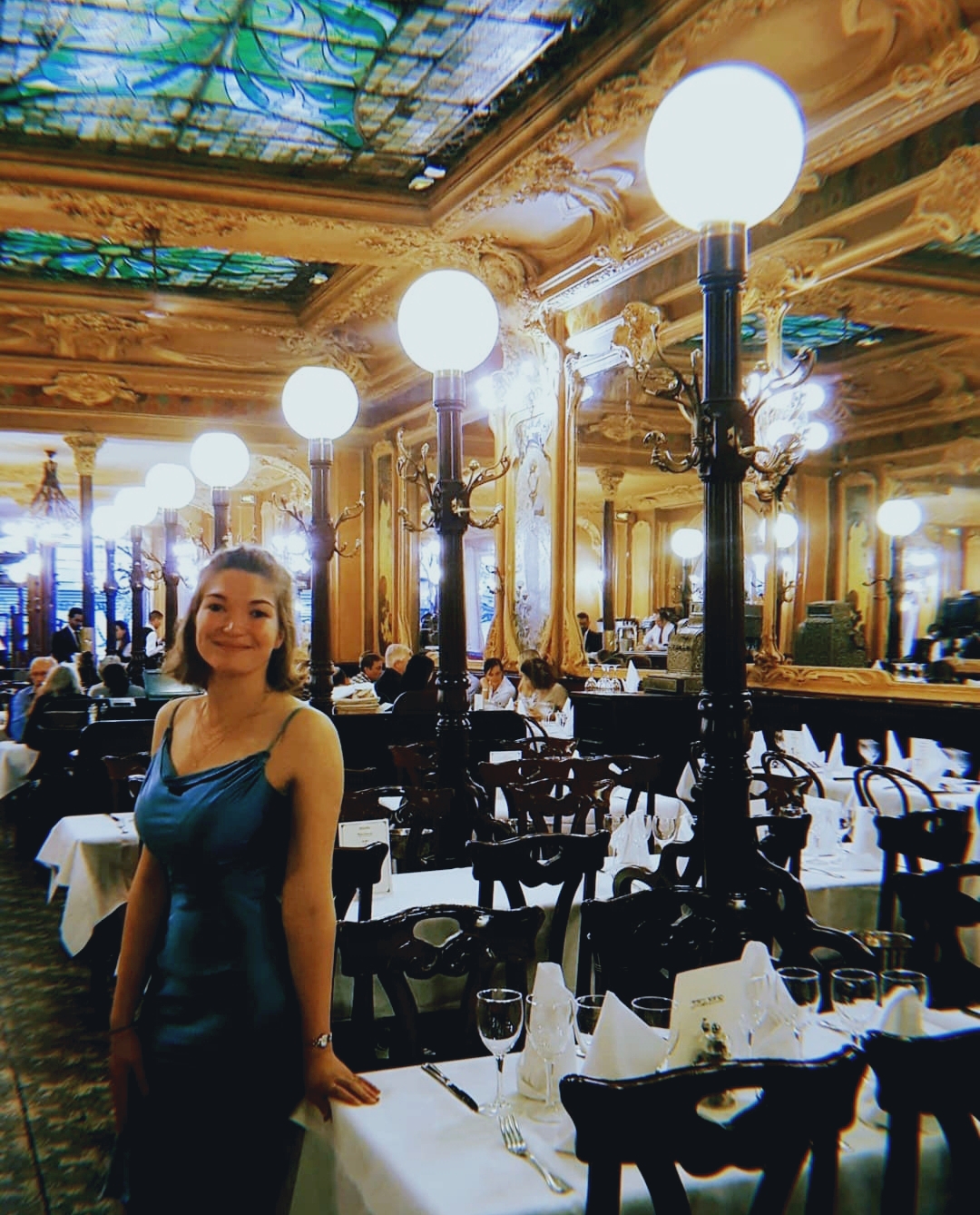 woman in restaurant with art nouveau architecture style