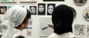 Students view an exhibition of work from VCUarts Qatar