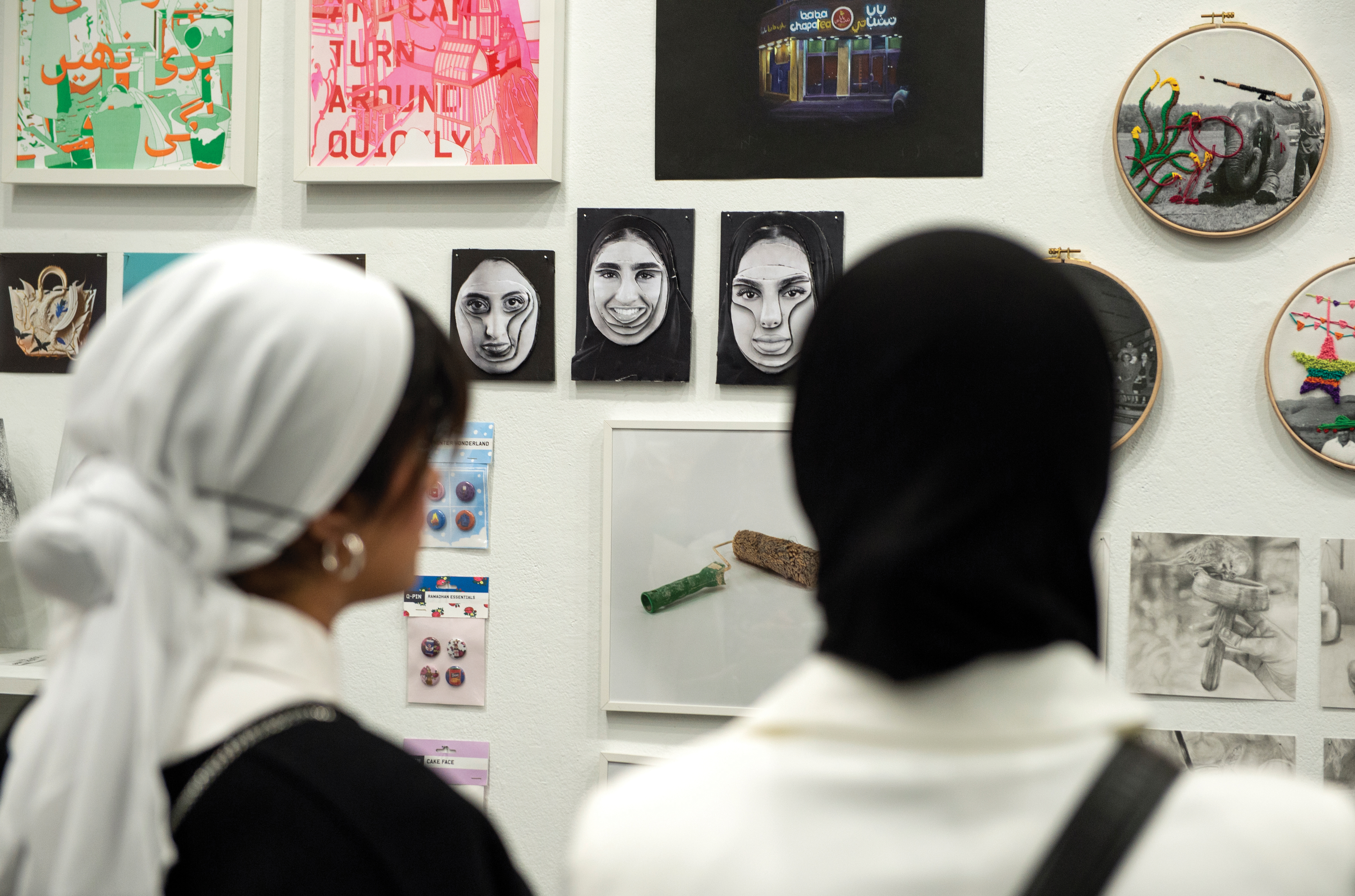 Students view an exhibition of work from VCUarts Qatar