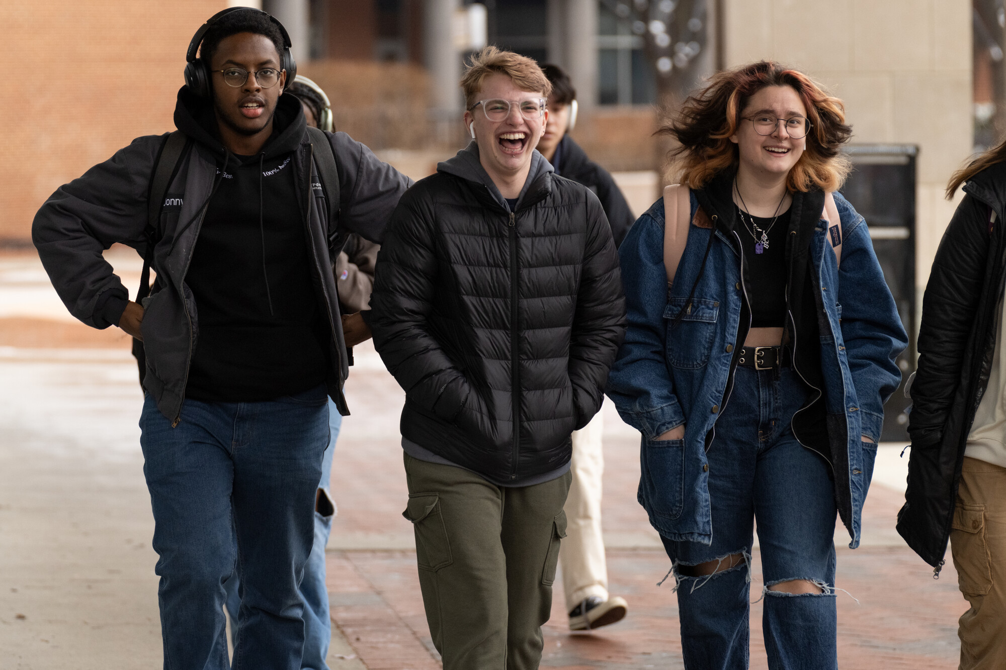 student on v c u campus walking on sidewalk having fun