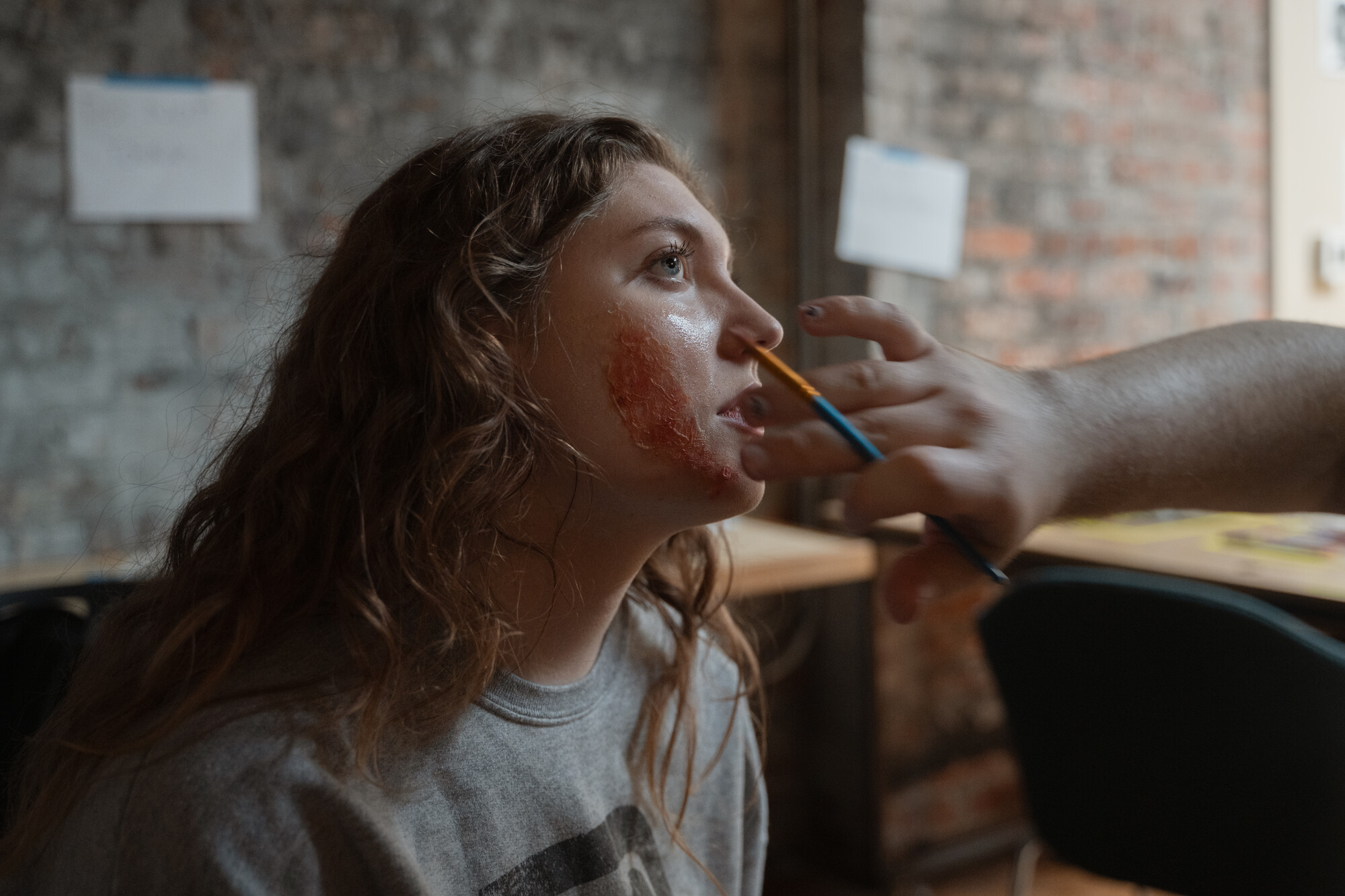 Student actor getting makeup done on set