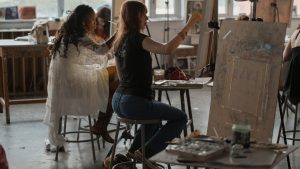 Students painting in a studio