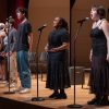 pre-college students singing on stage