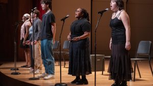 pre-college students singing on stage