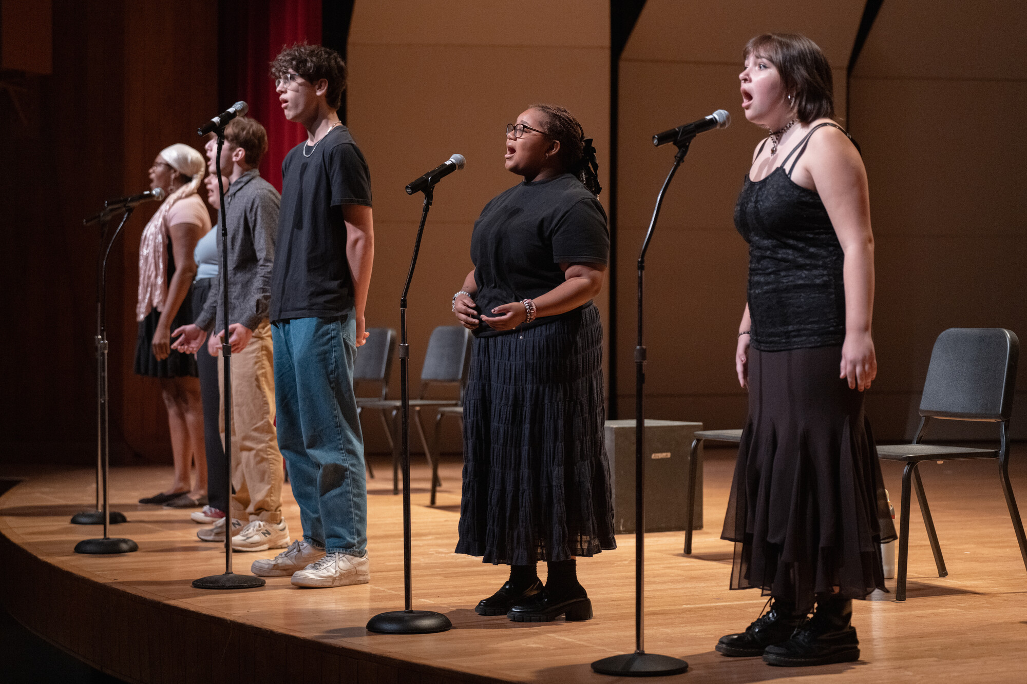 pre-college students singing on stage