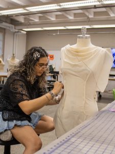 fashion student working on outfit in the classroom