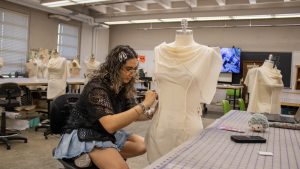 fashion student working on outfit in the classroom