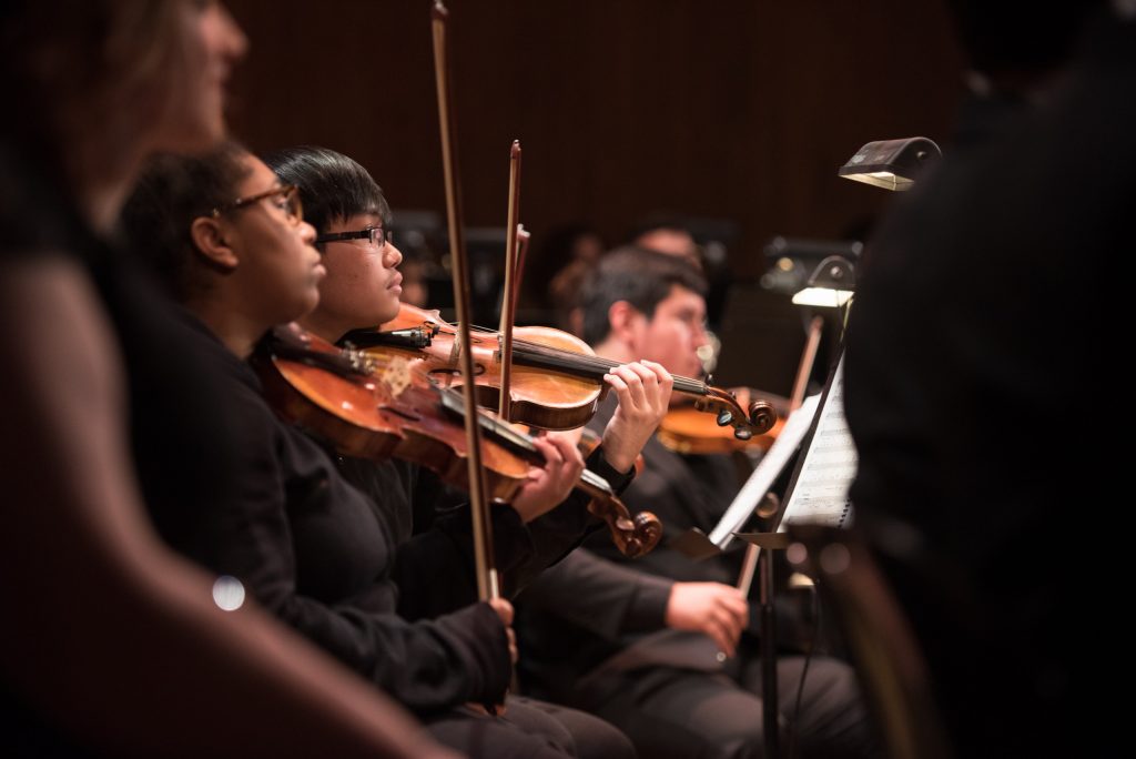 orchestra performance students playing violin