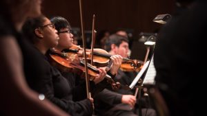 orchestra performance students playing violin