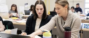 Interior design professor assisting student in the classroom