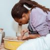 A student at the pottery wheel in her studio