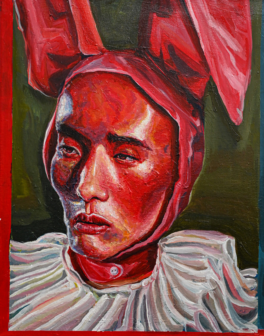 Portrait from the shoulders up of a young person wearing a clown collar and a bunny ear hat painted in shades and tints of red on a green background