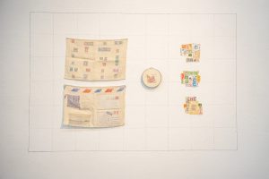 This is a map; a memory. Used stamps are woven into double-cloth pockets, embroidered, and stitched together, to think about all stamps ever sent and messages received across impossible distances.