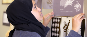 A woman pinning posters to a wall