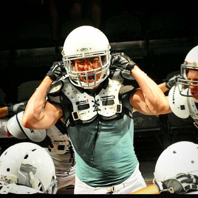 actor in football gear with arms raised