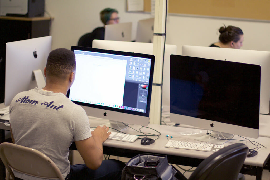 student working on computer in a computer lab