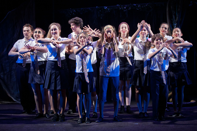 young people on stage in costumes