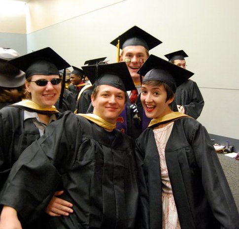 four people in caps and gowns