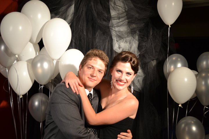 man and woman posing with balloons