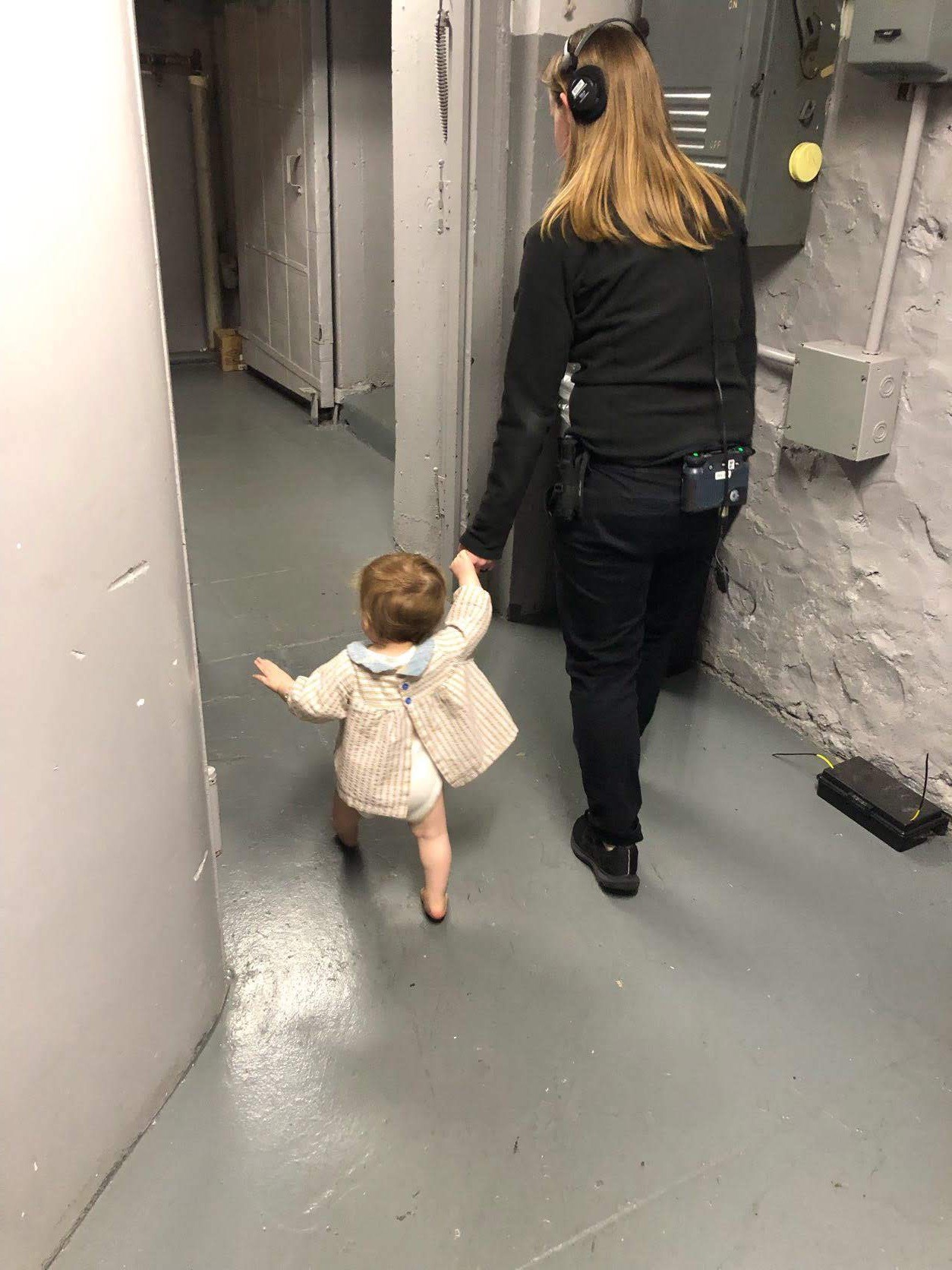 woman holding baby's hand backstage