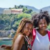 two students standing in front of scenic landscape studying abroad