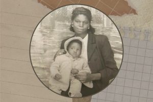 There is a pile of scrapbook paper with various colors and textures in the background. In the center, there is an old photo of a young black woman holding a baby on her lap. The baby is wearing a bonnet.